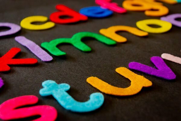 Colorful felt letters on a dark background